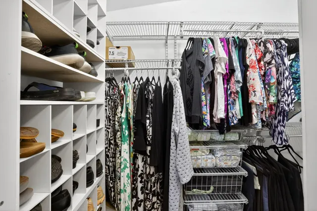 a view of house with yard and trees in the background