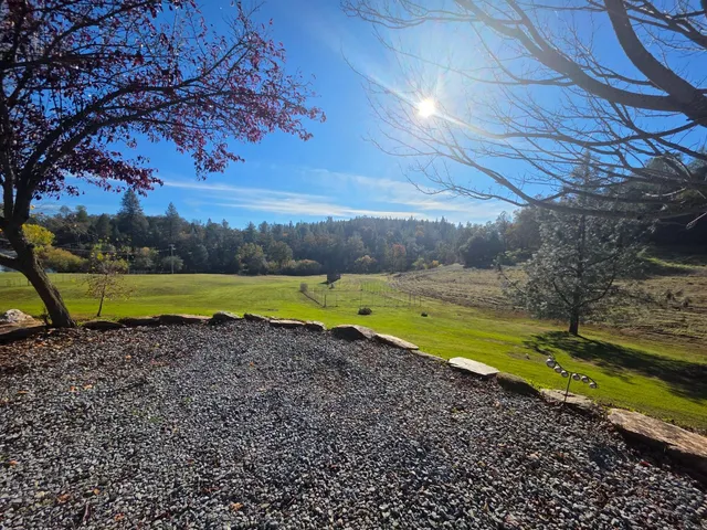 a kitchen with stainless steel appliances granite countertop a sink refrigerator and cabinets