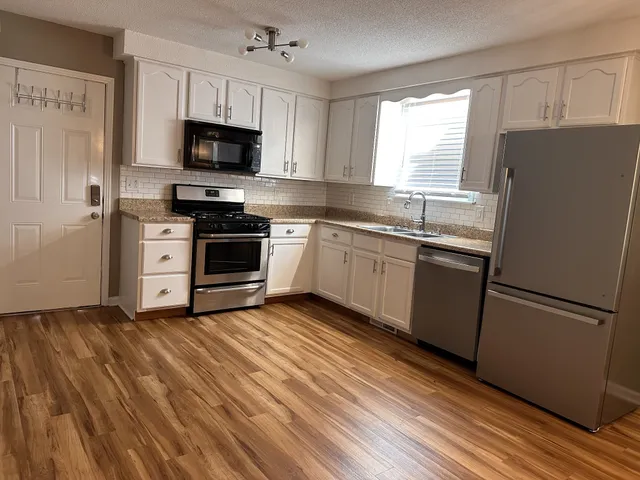 a kitchen with a refrigerator stove and microwave
