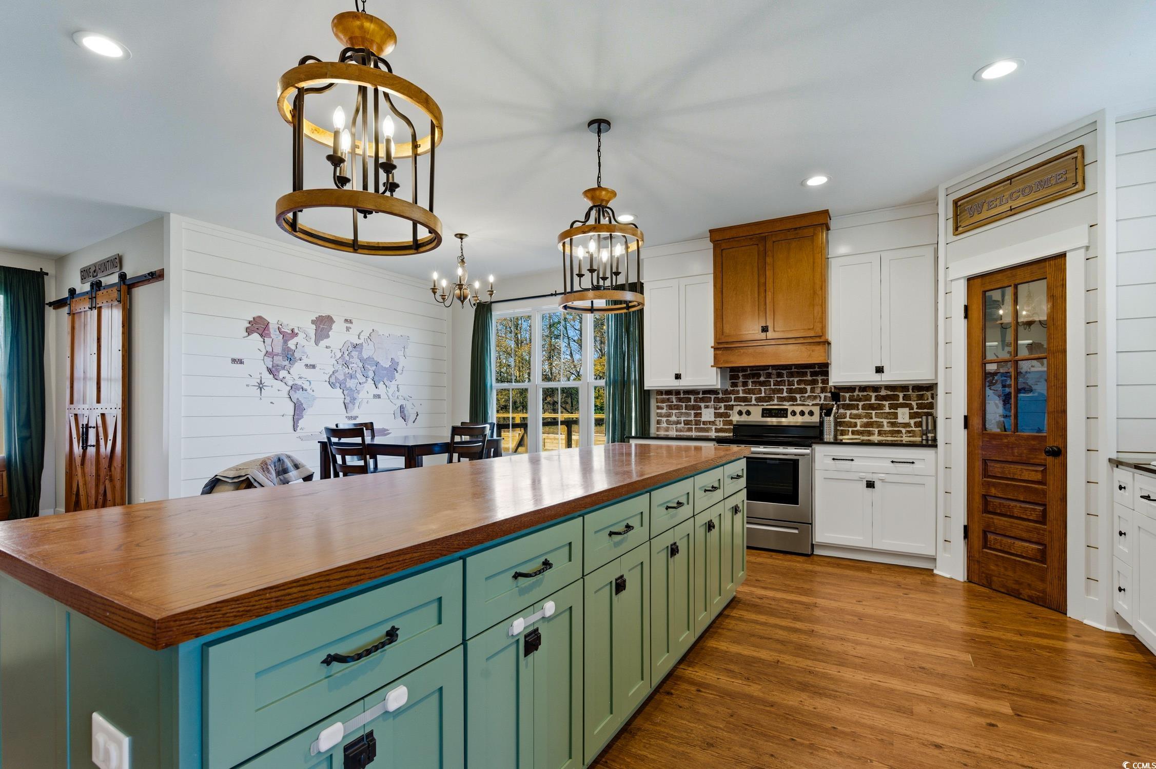 851 Dog Bluff Road Galivants Ferry, SC 29544 - Photo 4 of 25 Kitchen with green cabinetry, a barn door, wooden counters, recessed lighting, and light wood-style flooring