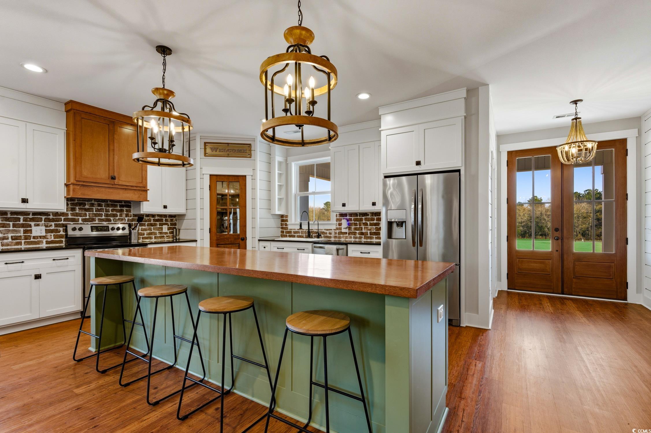 851 Dog Bluff Road Galivants Ferry, SC 29544 - Photo 5 of 25 Kitchen featuring a chandelier, pendant lighting, white cabinets, appliances with stainless steel finishes, and recessed lighting