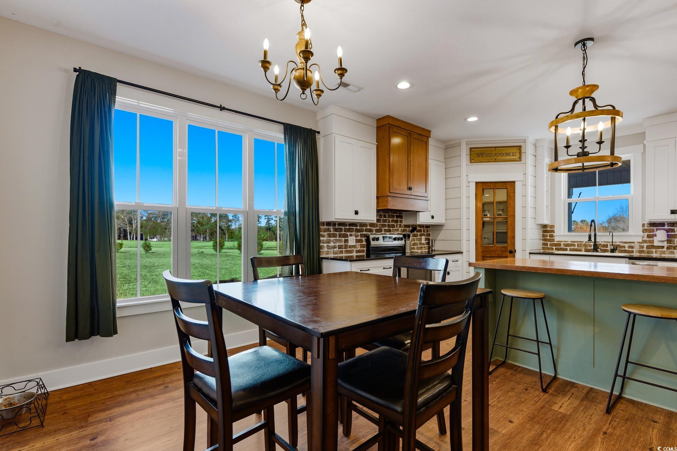 851 Dog Bluff Road Galivants Ferry, SC 29544 - Photo 6 of 25 Dining area featuring a chandelier, light wood-style flooring, and recessed lighting