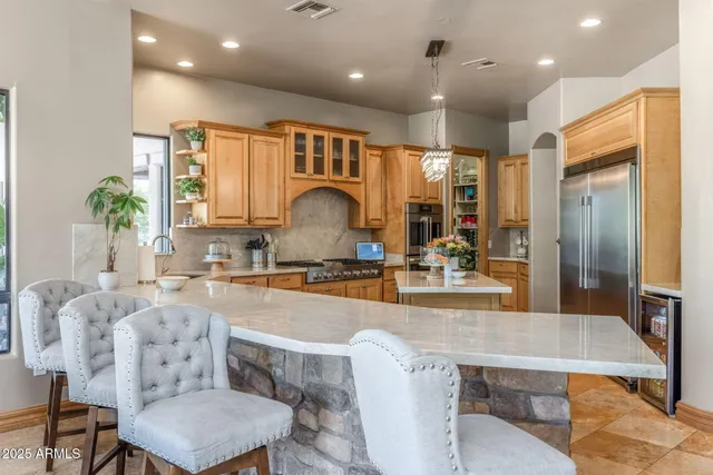 a kitchen with stainless steel appliances granite countertop a sink and cabinets