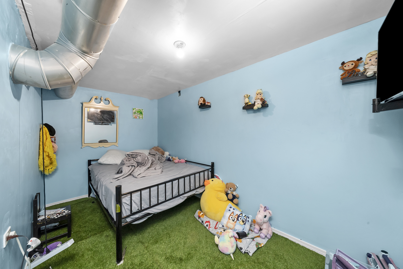 149 East 120th Street Chicago, IL 60628 - Photo 11 of 18 a bedroom with a bed and a chandelier