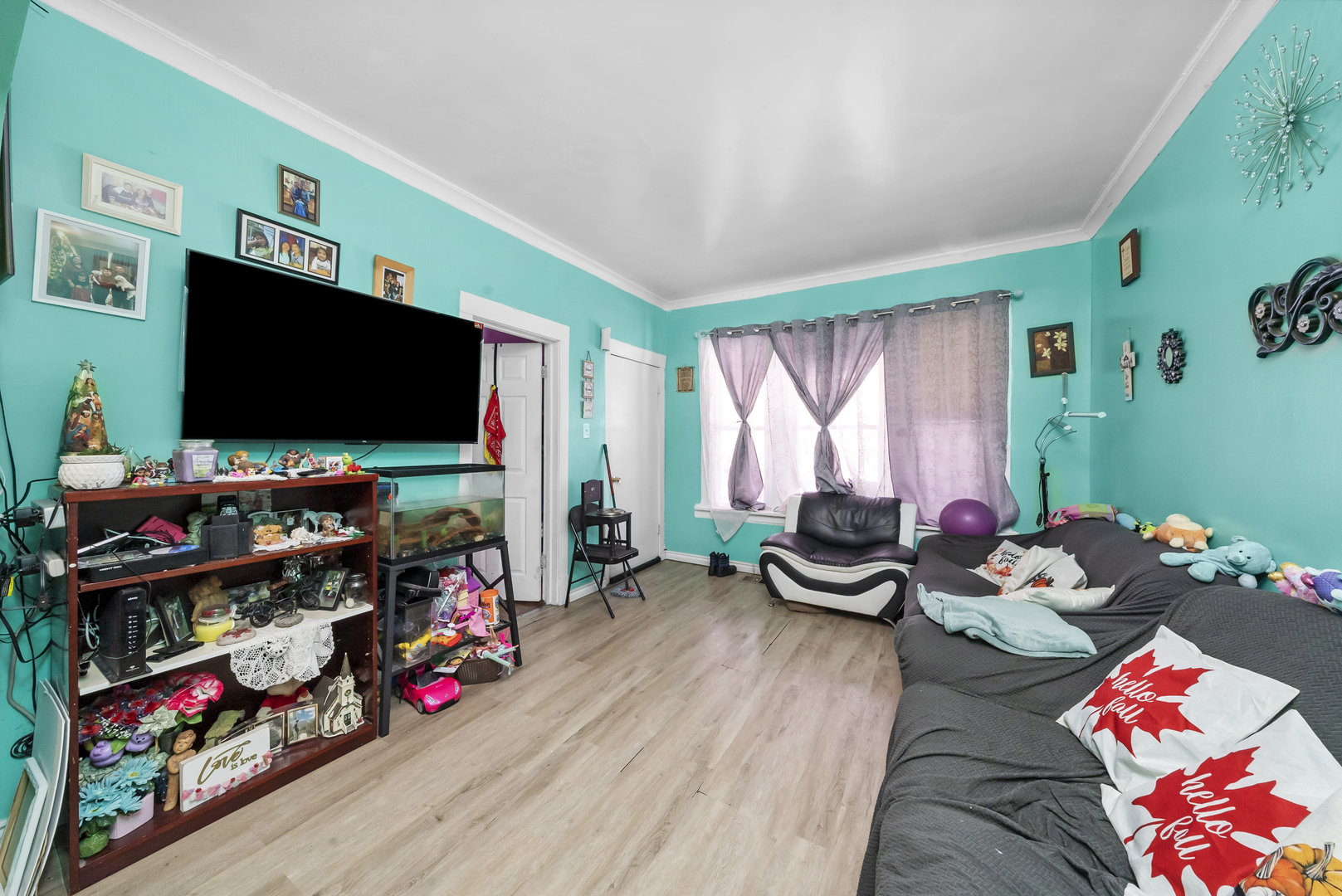 149 East 120th Street Chicago, IL 60628 - Photo 5 of 18 a bedroom with furniture and a flat screen tv