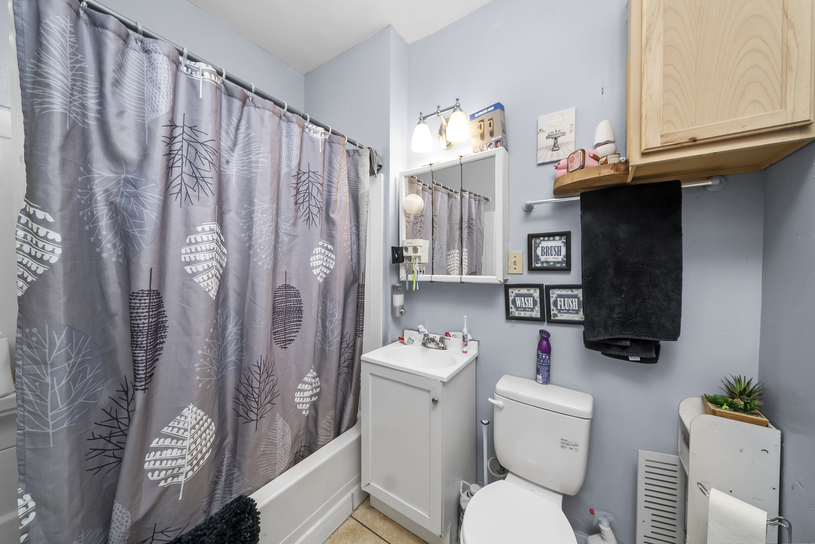 149 East 120th Street Chicago, IL 60628 - Photo 7 of 18 a bathroom with a sink toilet and shower