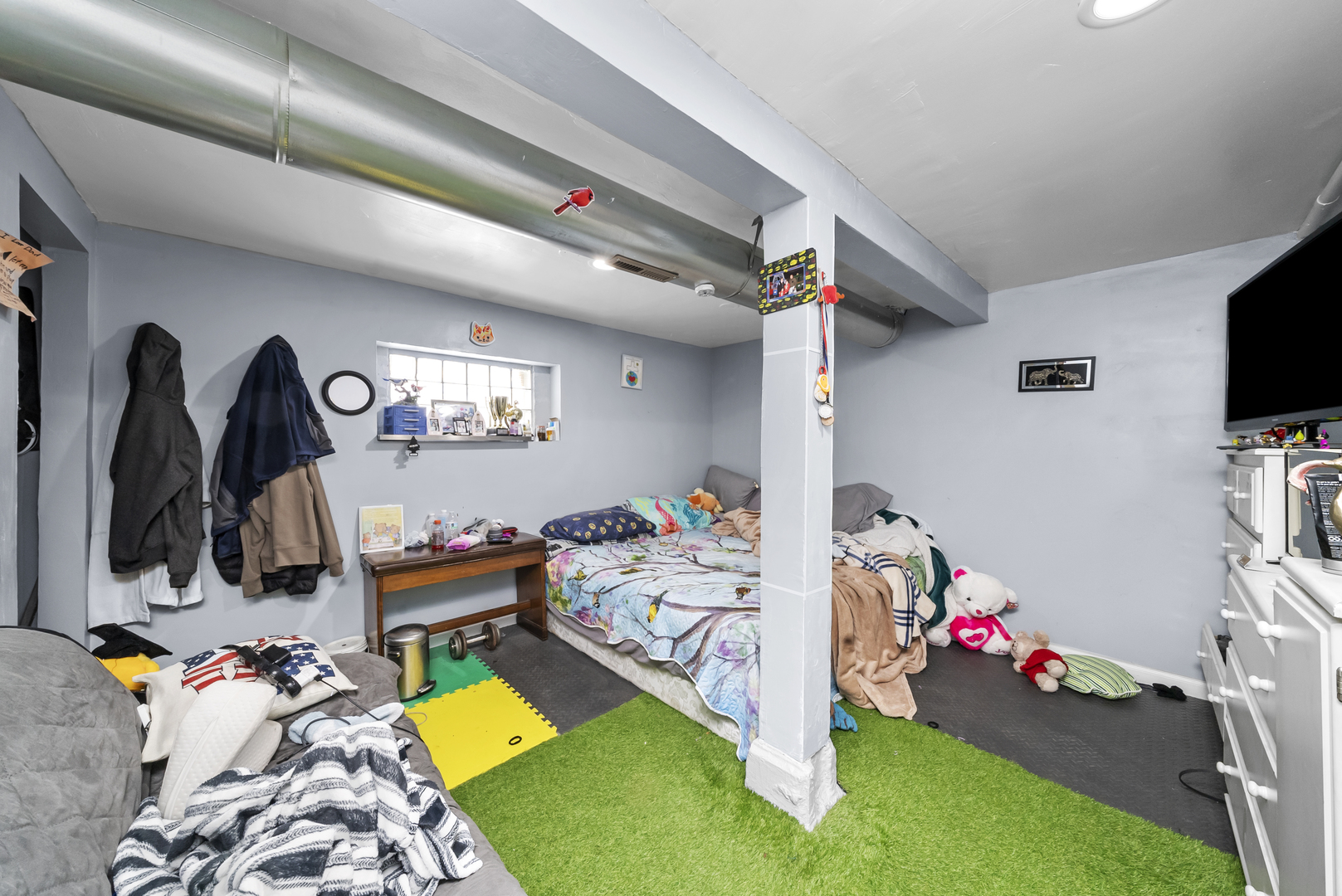 149 East 120th Street Chicago, IL 60628 - Photo 10 of 18 a bed room with a bed and a tv