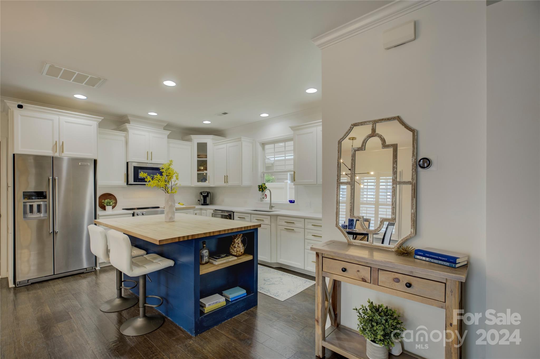 3478 Richard's Crossing Fort Mill, SC 29708 - Photo 6 of 30 a kitchen with stainless steel appliances granite countertop a table chairs sink and stove top oven