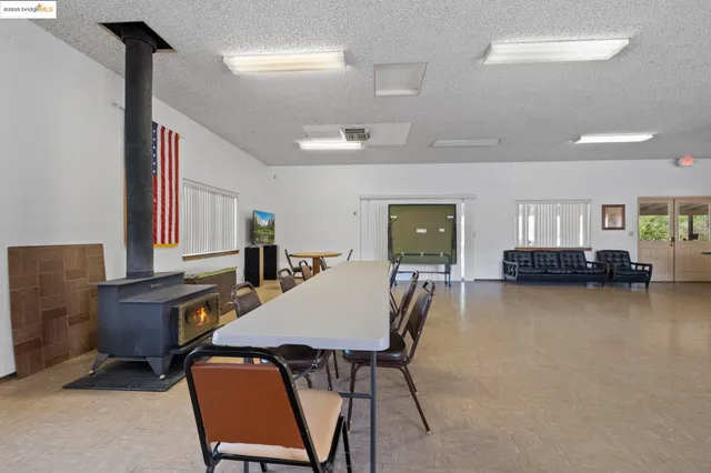 a view of a workspace with furniture and window
