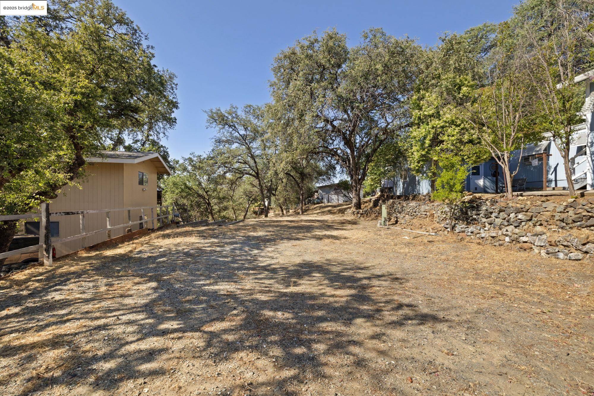 8400 Old Melones Dam Road, Unit 52 Jamestown, CA 95327 - Photo 2 of 21 a view of yard covered with trees