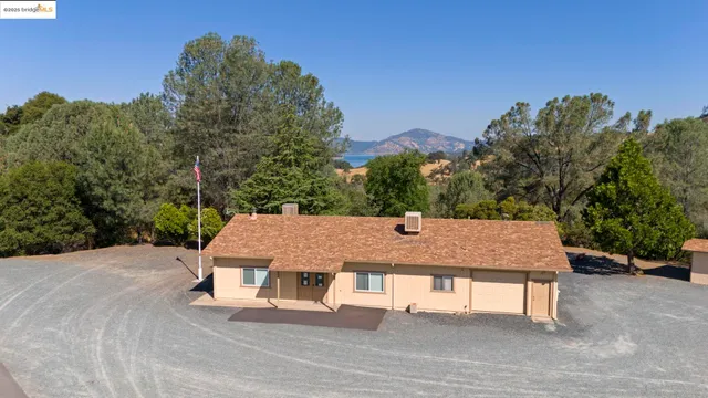 a view of a patio with table and chairs with wooden floor and fence