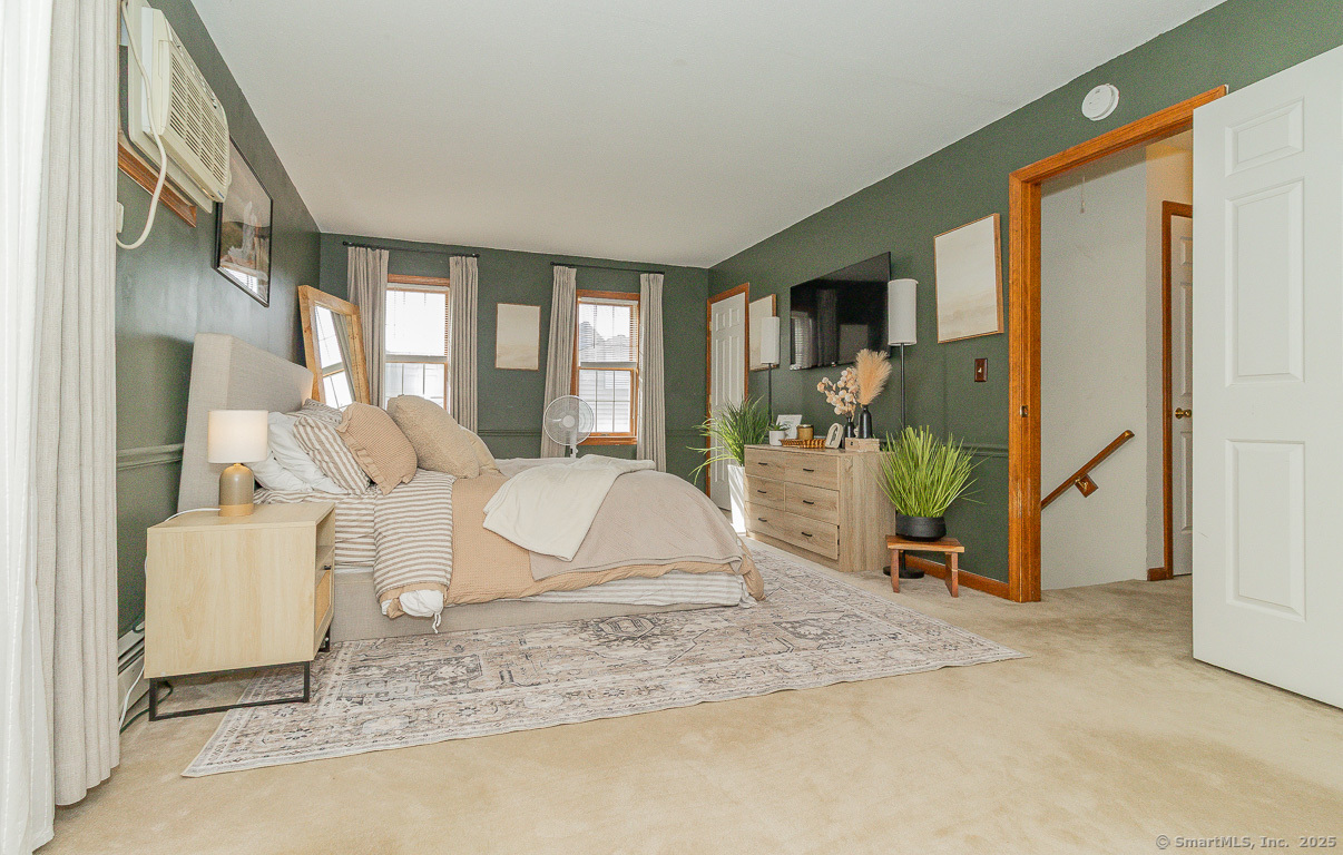 27 Deer Run Trail Manchester, CT 06042 - Photo 20 of 40 a living room with furniture a flat screen tv and a floor to ceiling window