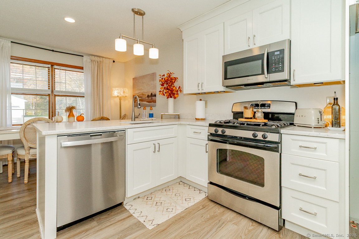 27 Deer Run Trail Manchester, CT 06042 - Photo 2 of 40 a kitchen with stainless steel appliances a stove microwave and a sink