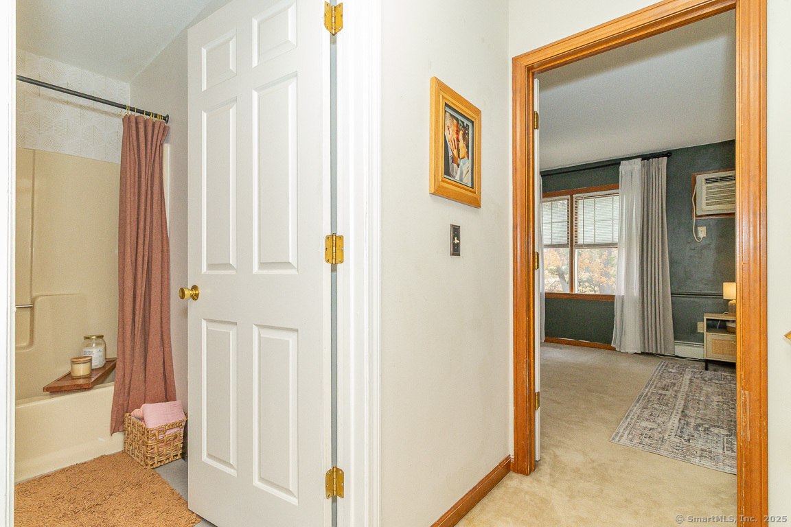 27 Deer Run Trail Manchester, CT 06042 - Photo 31 of 40 a view of a hallway with wooden floor and a livingroom