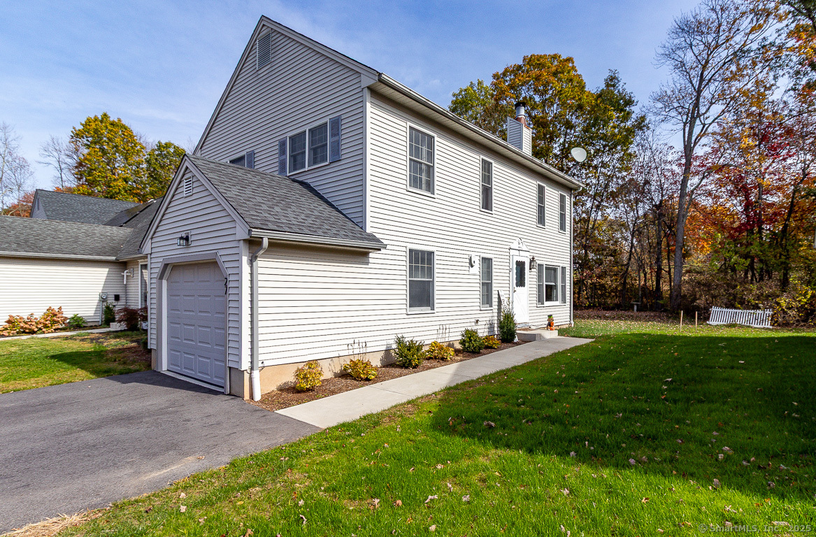 27 Deer Run Trail Manchester, CT 06042 - Photo 37 of 40 a front view of a house with a garden and trees