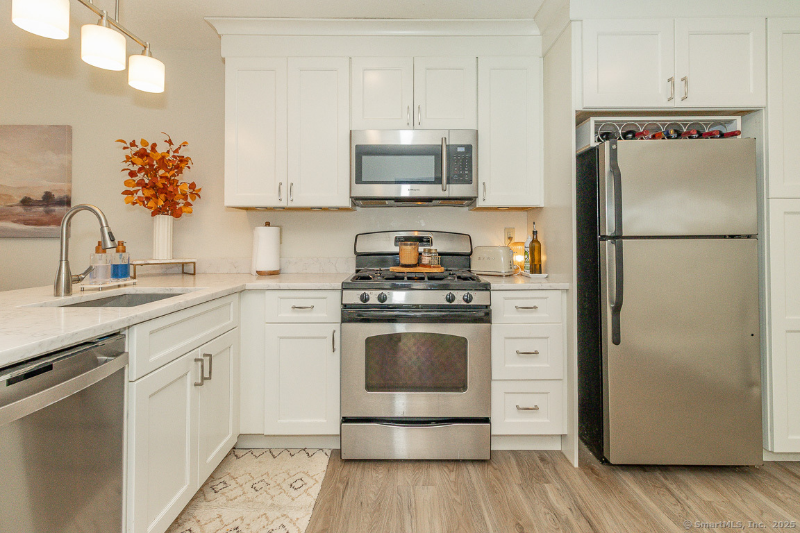 27 Deer Run Trail Manchester, CT 06042 - Photo 5 of 40 a kitchen with a refrigerator sink and microwave