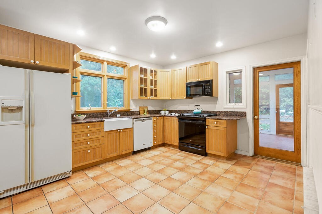 67 Coolidge Road Arlington, MA 02476 - Photo 11 of 34 a kitchen with stainless steel appliances granite countertop a stove a sink dishwasher a refrigerator and a microwave