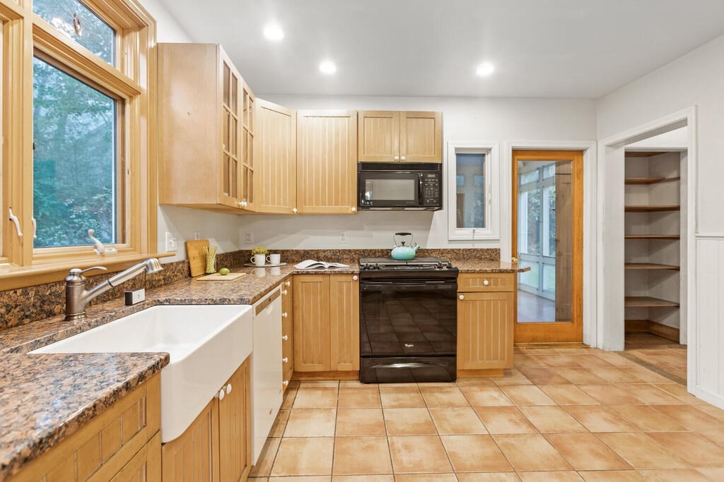67 Coolidge Road Arlington, MA 02476 - Photo 12 of 34 a kitchen with stainless steel appliances granite countertop a sink stove and refrigerator