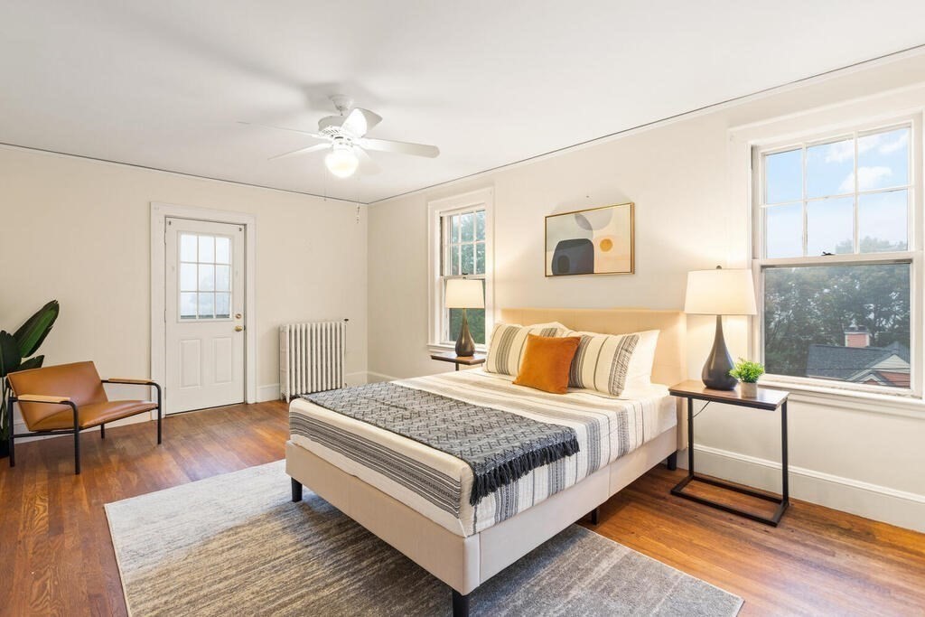 67 Coolidge Road Arlington, MA 02476 - Photo 16 of 34 a bedroom with a bed and wooden floor