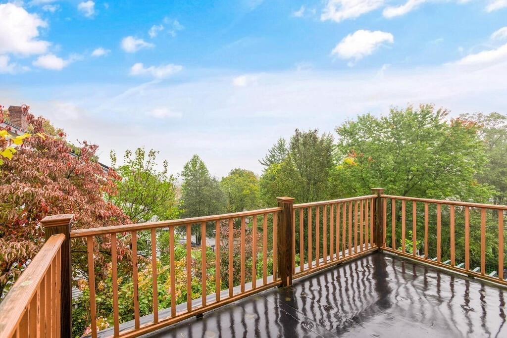 67 Coolidge Road Arlington, MA 02476 - Photo 18 of 34 a view of a balcony with wooden fence