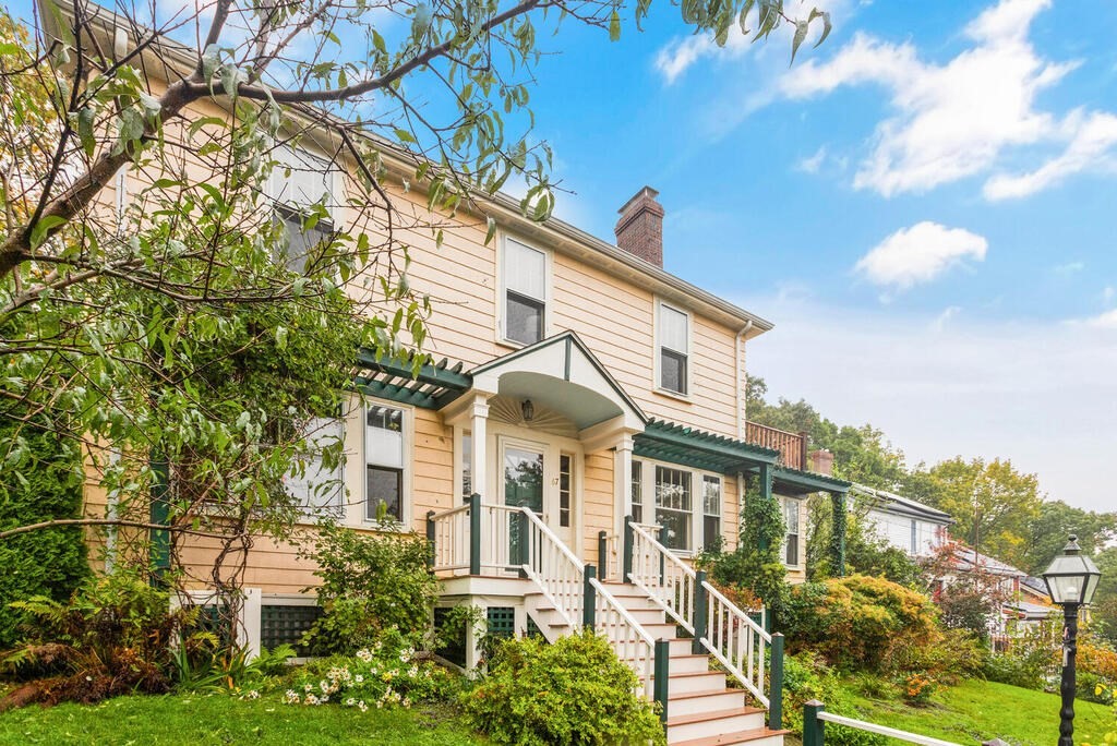 67 Coolidge Road Arlington, MA 02476 - Photo 2 of 34 a front view of a house with a yard