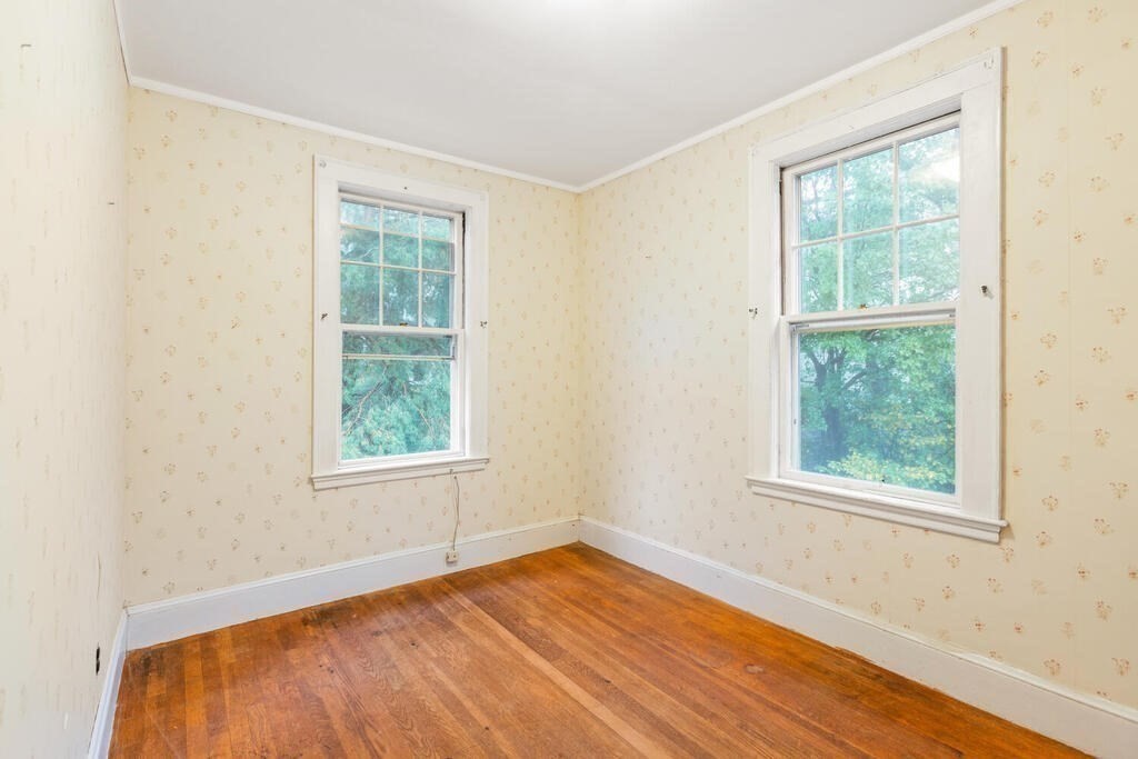 67 Coolidge Road Arlington, MA 02476 - Photo 22 of 34 an empty room with wooden floor and windows