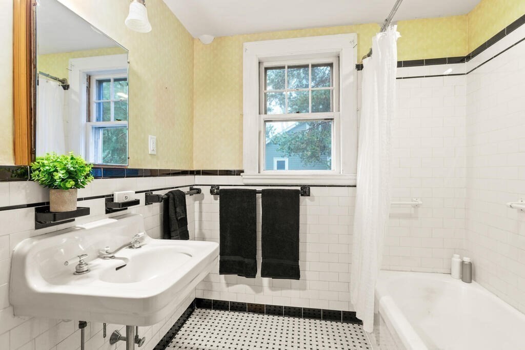 67 Coolidge Road Arlington, MA 02476 - Photo 23 of 34 a bathroom with a sink a mirror and a shower