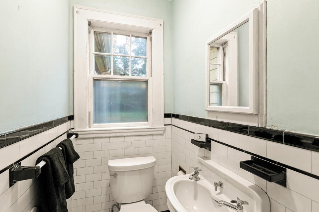 67 Coolidge Road Arlington, MA 02476 - Photo 24 of 34 a bathroom with a sink a toilet and a window
