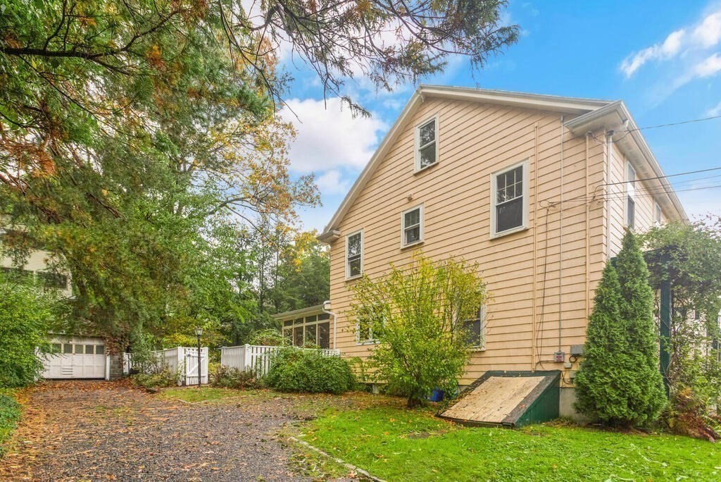 67 Coolidge Road Arlington, MA 02476 - Photo 30 of 34 a view of a house with a yard