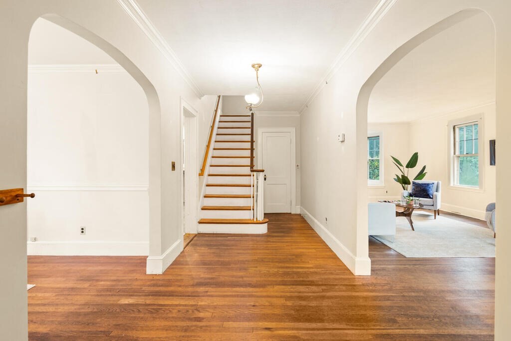 67 Coolidge Road Arlington, MA 02476 - Photo 3 of 34 a view of a room with wooden floor and chairs