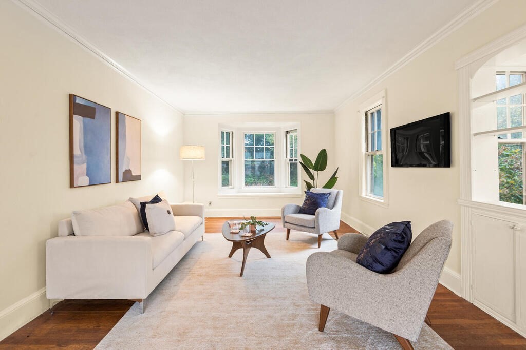 67 Coolidge Road Arlington, MA 02476 - Photo 6 of 34 a living room with furniture a flat screen tv and a window