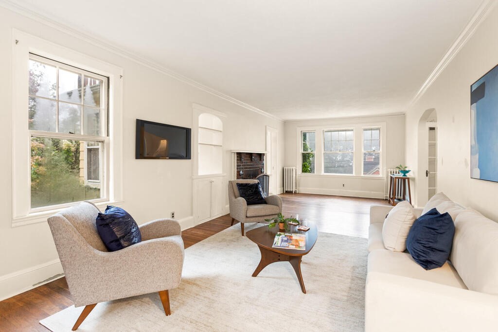 67 Coolidge Road Arlington, MA 02476 - Photo 7 of 34 a living room with furniture a flat screen tv and a large window