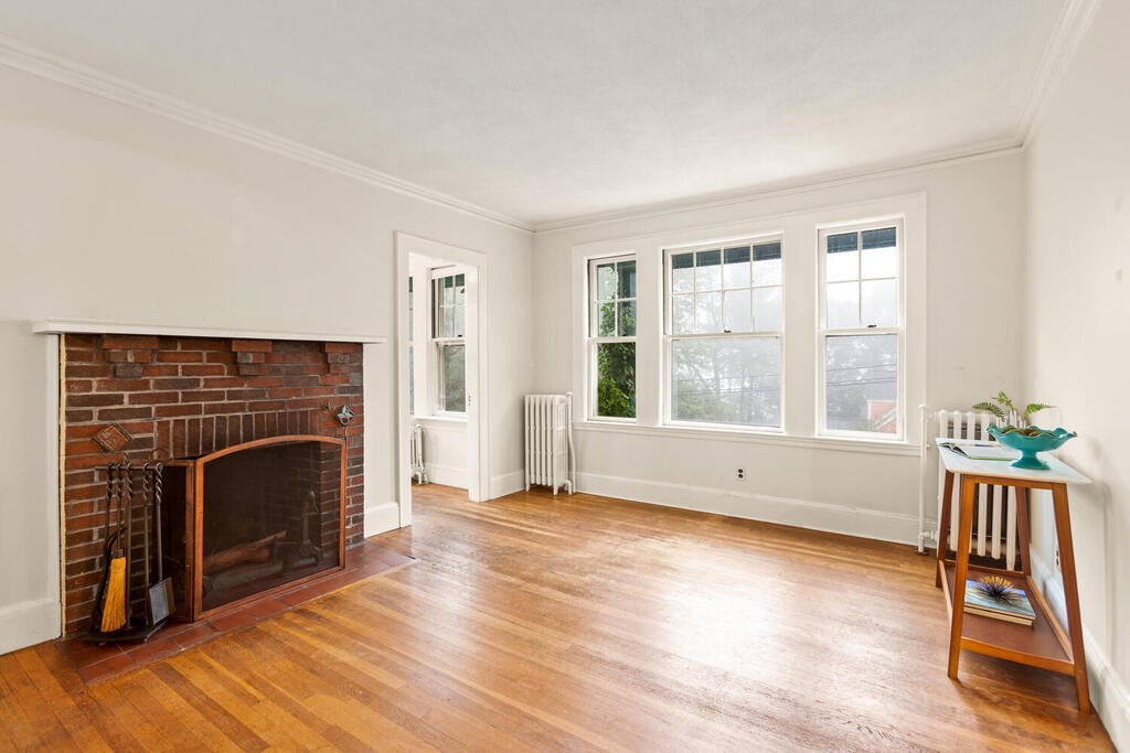 67 Coolidge Road Arlington, MA 02476 - Photo 8 of 34 a view of an empty room with wooden floor and a window