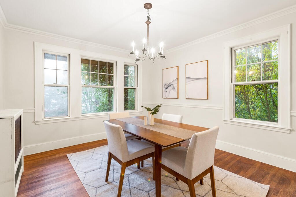 67 Coolidge Road Arlington, MA 02476 - Photo 9 of 34 a dining room with wooden floor a chandelier a wooden table and chairs