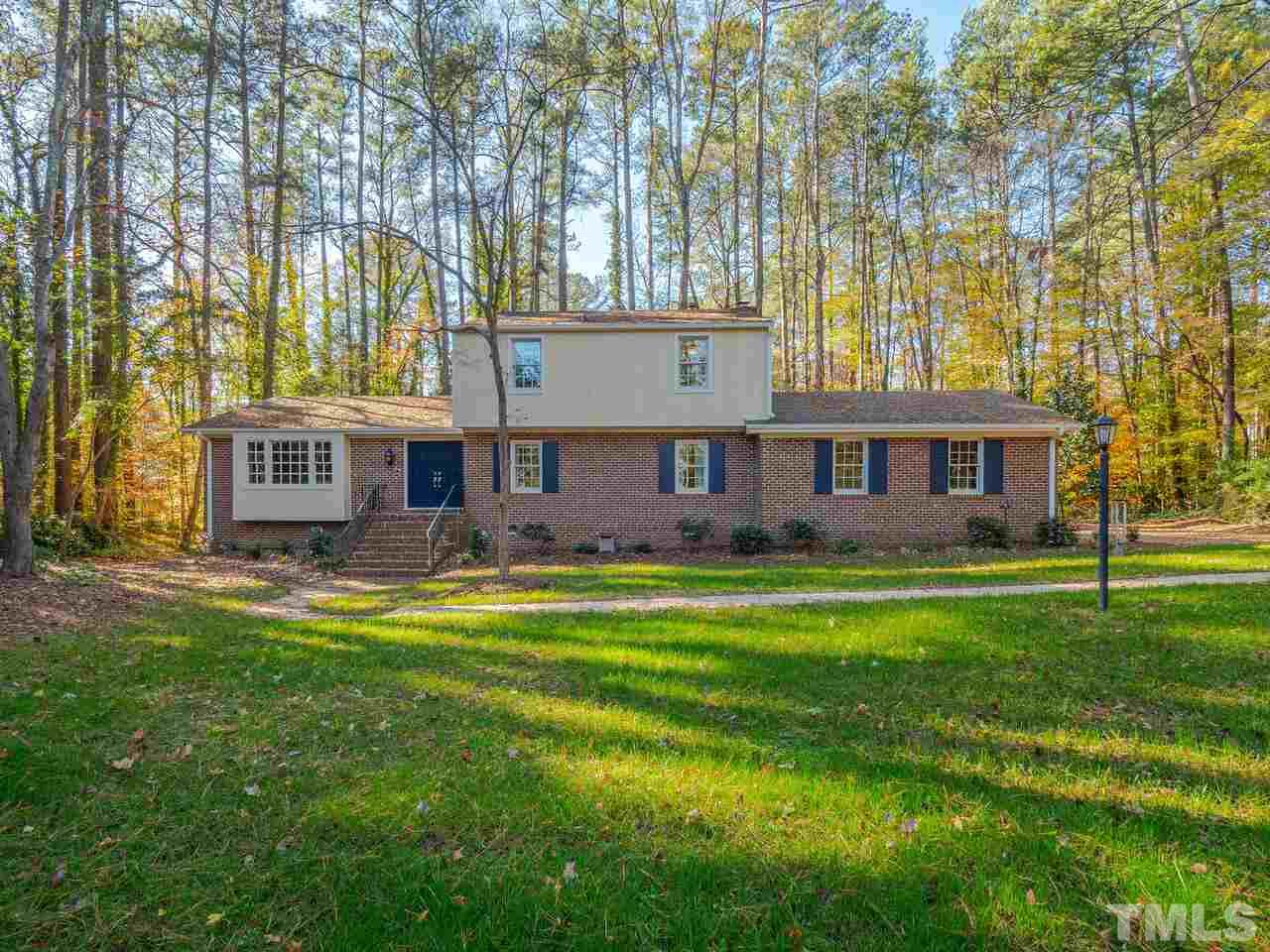 4604 Fernham Place Raleigh, NC 27612 - Photo 1 of 30 a view of a house with a big yard and large trees