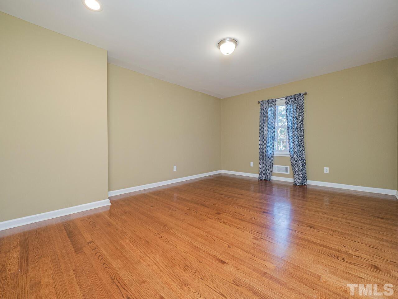 4604 Fernham Place Raleigh, NC 27612 - Photo 12 of 30 a view of an empty room with wooden floor