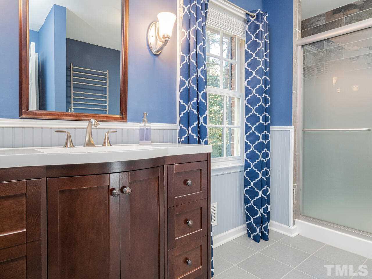 4604 Fernham Place Raleigh, NC 27612 - Photo 14 of 30 a bathroom with a sink and a mirror