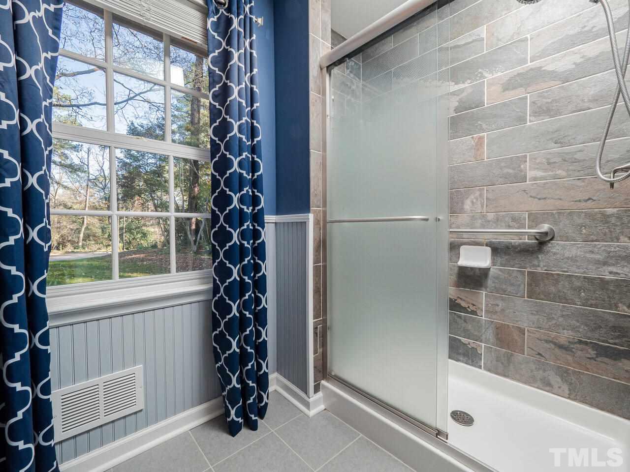 4604 Fernham Place Raleigh, NC 27612 - Photo 15 of 30 a bathroom with a bathtub