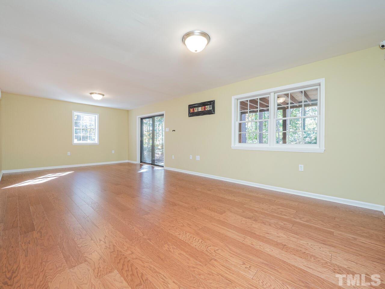 4604 Fernham Place Raleigh, NC 27612 - Photo 19 of 30 a view of an empty room with wooden floor and a window