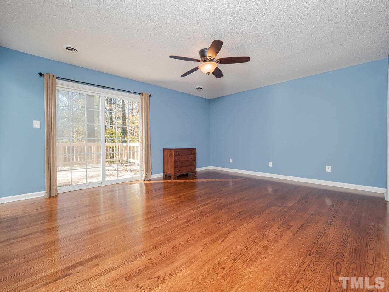 4604 Fernham Place Raleigh, NC 27612 - Photo 21 of 30 a view of an empty room with wooden floor and a window