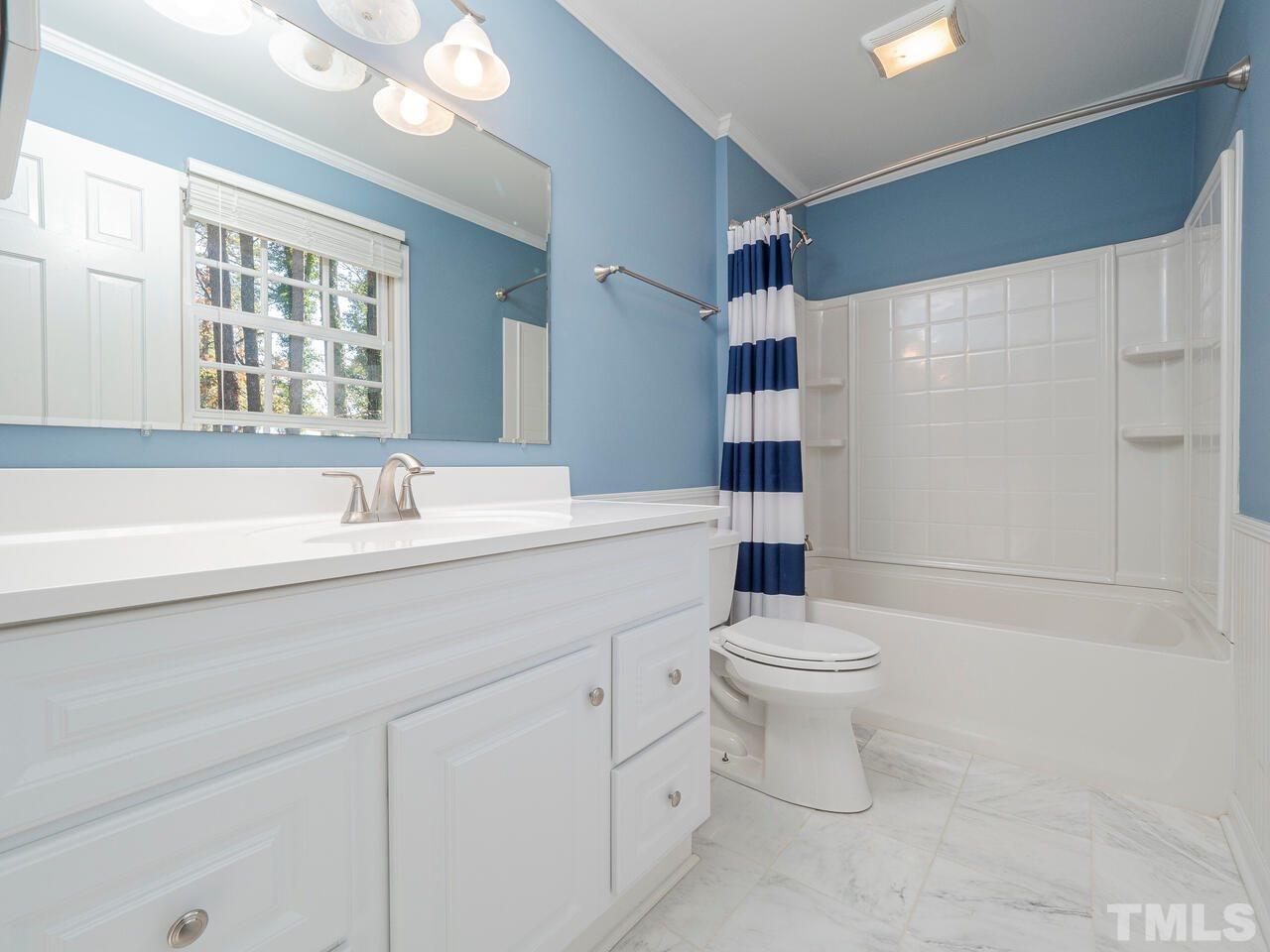 4604 Fernham Place Raleigh, NC 27612 - Photo 23 of 30 a bathroom with a sink a toilet and shower