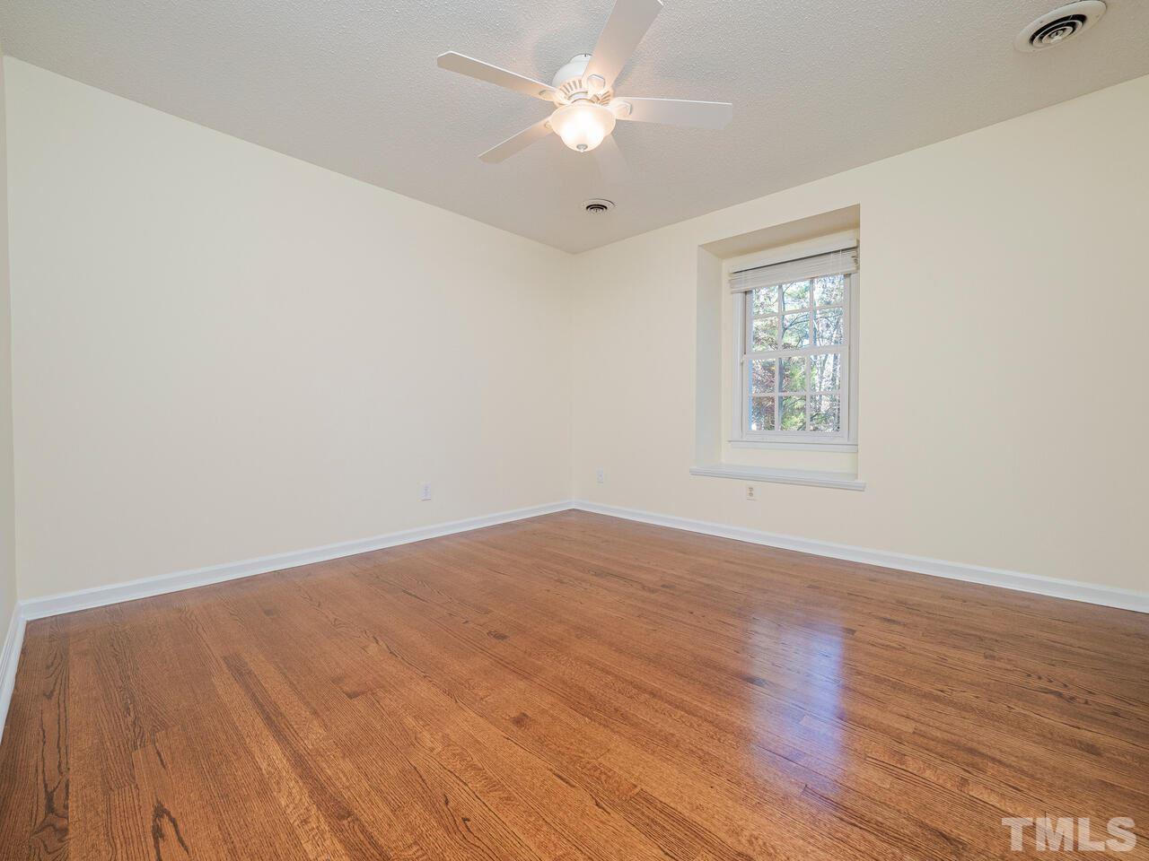 4604 Fernham Place Raleigh, NC 27612 - Photo 24 of 30 an empty room with wooden floor and windows