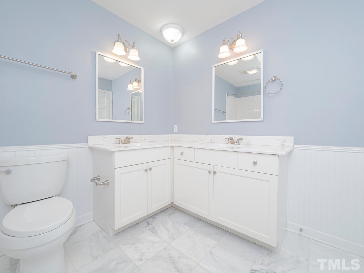 4604 Fernham Place Raleigh, NC 27612 - Photo 26 of 30 a bathroom with a toilet sink and mirror