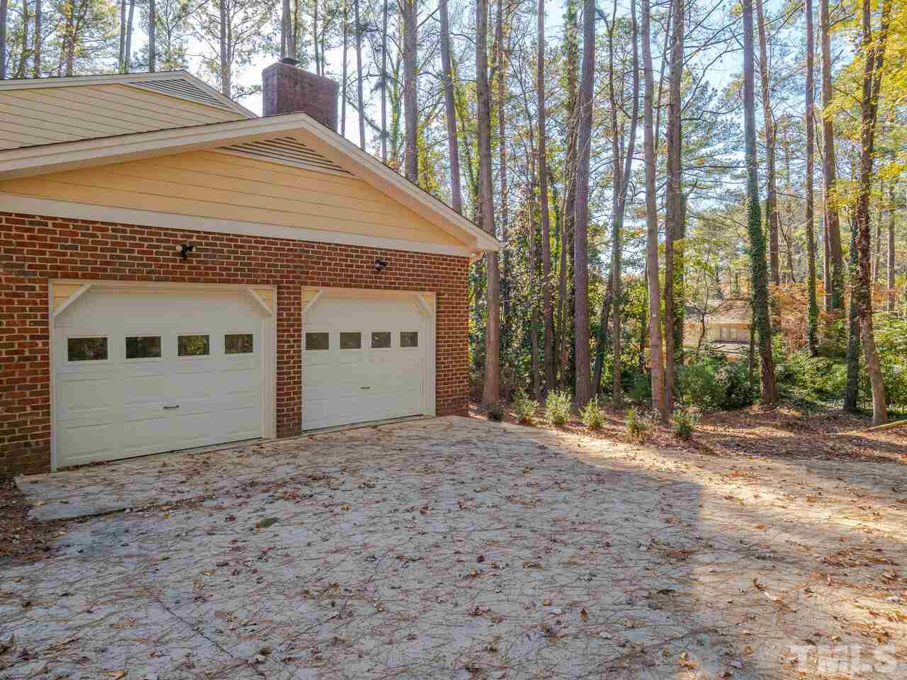 4604 Fernham Place Raleigh, NC 27612 - Photo 28 of 30 a front view of a house with a yard and garage