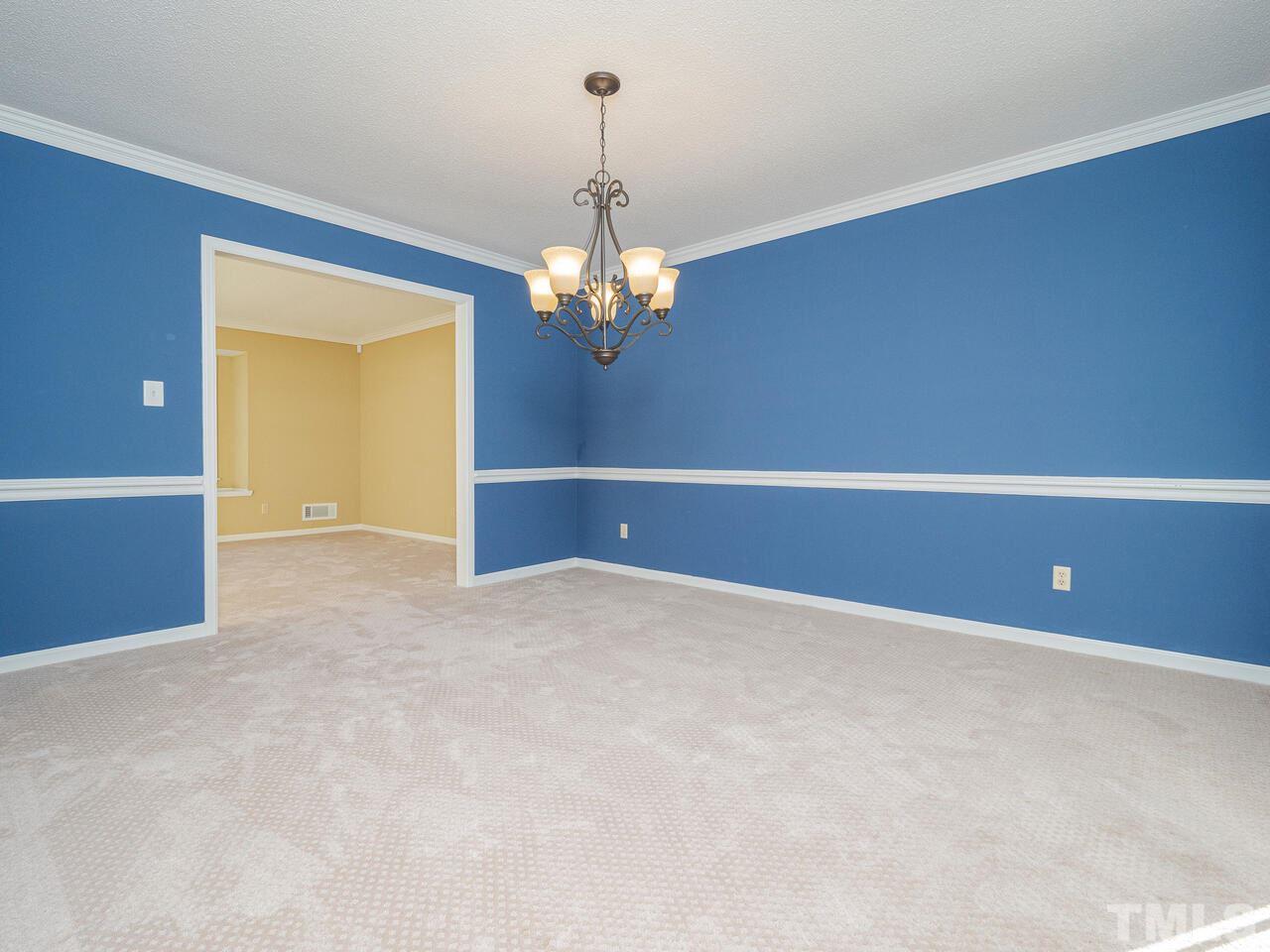 4604 Fernham Place Raleigh, NC 27612 - Photo 4 of 30 a view of an empty room with a chandelier