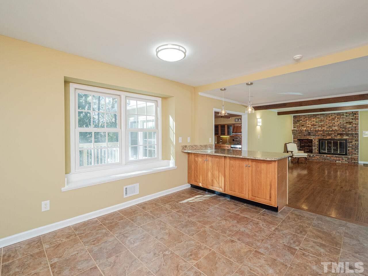 4604 Fernham Place Raleigh, NC 27612 - Photo 8 of 30 a large kitchen with a large counter top and stainless steel appliances