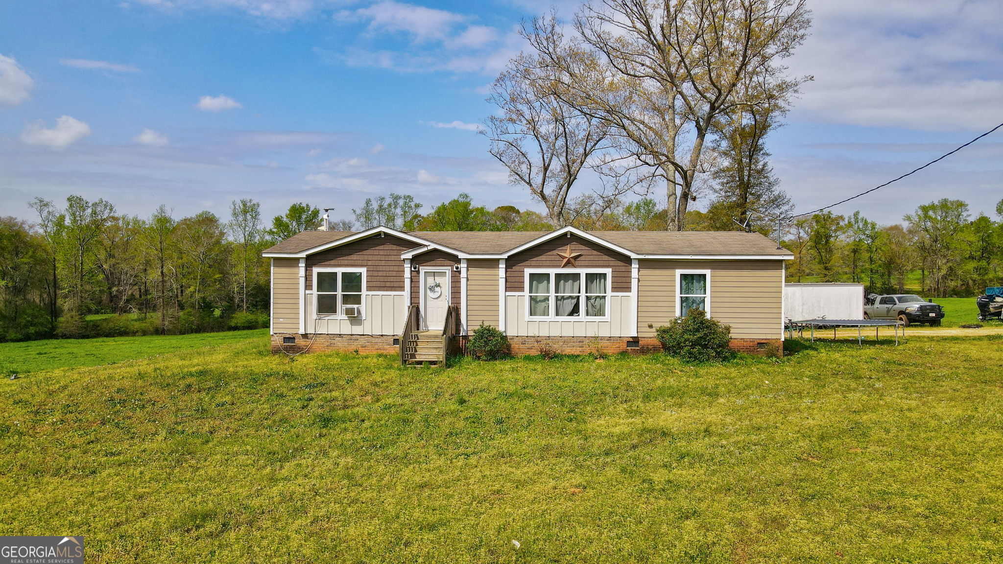 1291 Apalachee River Road Madison, GA 30650 - Photo 13 of 84 a front view of a house with a yard and trees