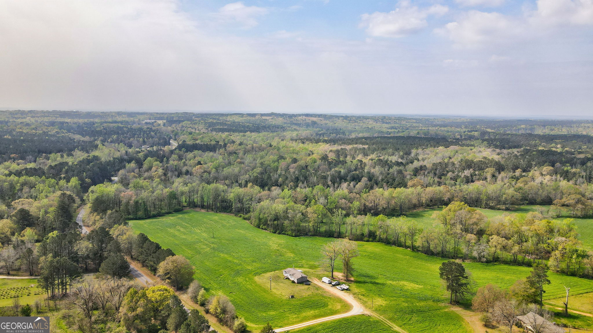 1291 Apalachee River Road Madison, GA 30650 - Photo 35 of 84 an aerial view of residential houses with outdoor space and trees