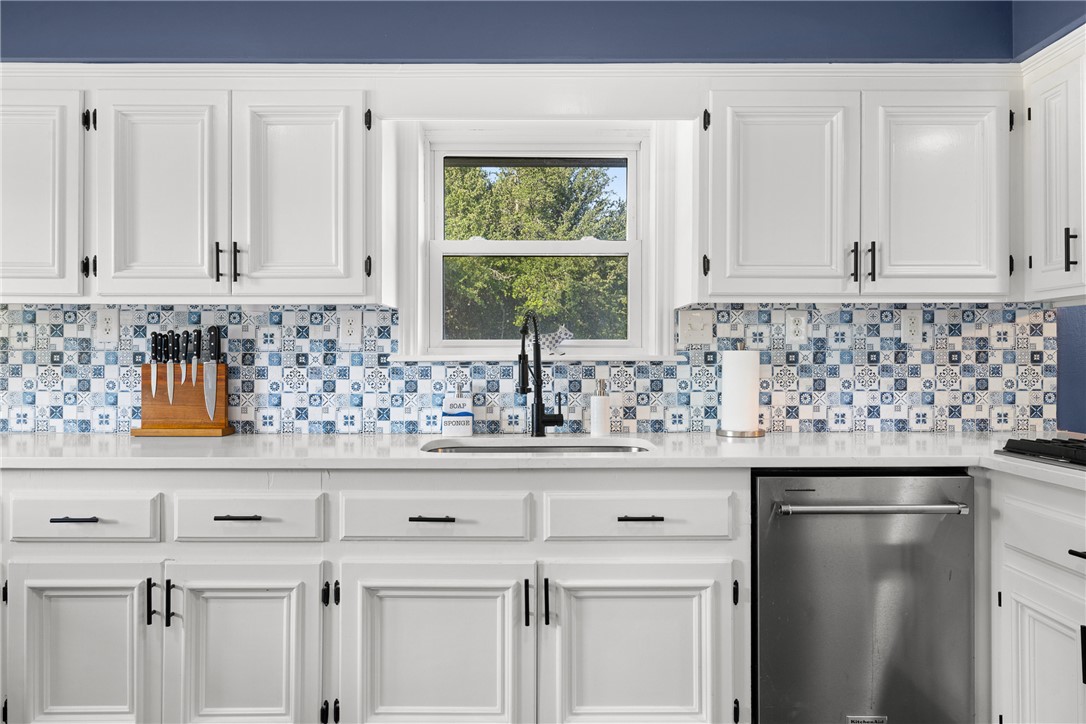 871 Cazey Loop Franklin, TX 77856 - Photo 15 of 42 a kitchen with granite countertop white cabinets and window