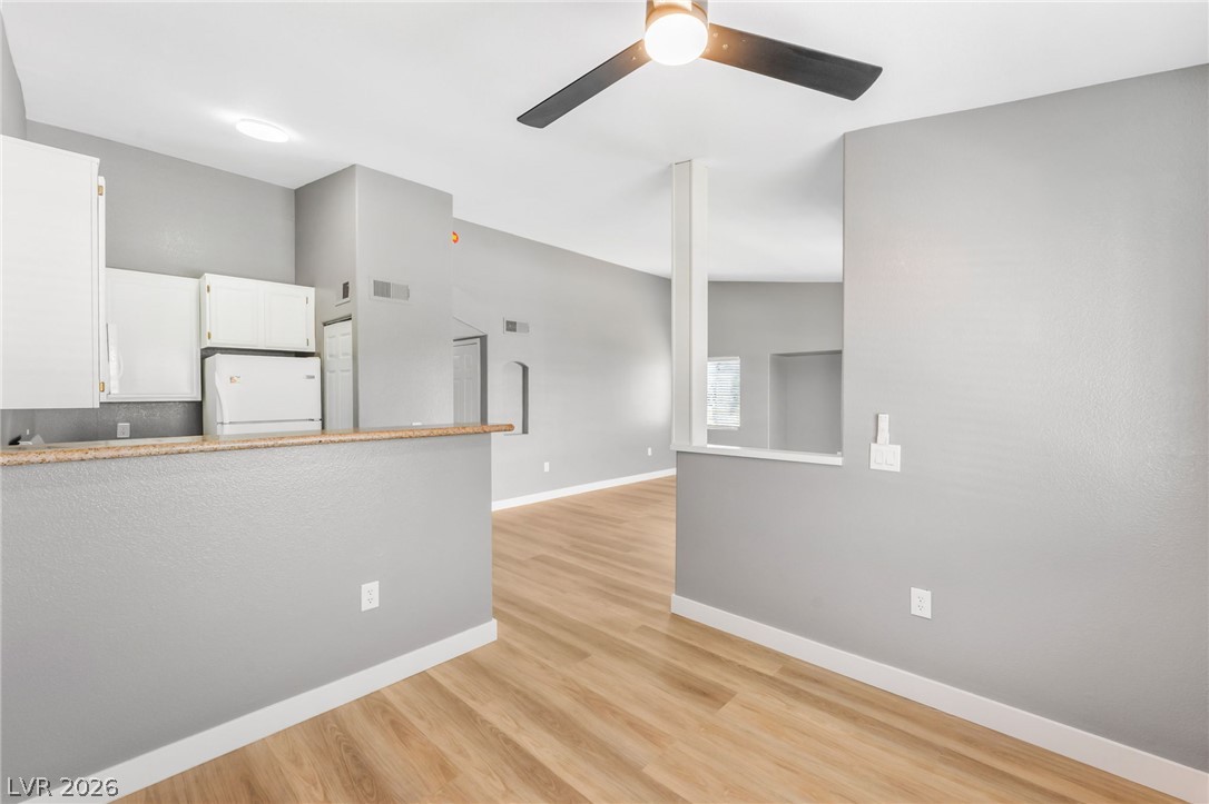 3318 North Decatur Boulevard, Unit 2152 Las Vegas, NV 89130 - Photo 11 of 58 The bright open concept living area boasts a modern ceiling fan and durable hardwood flooring.